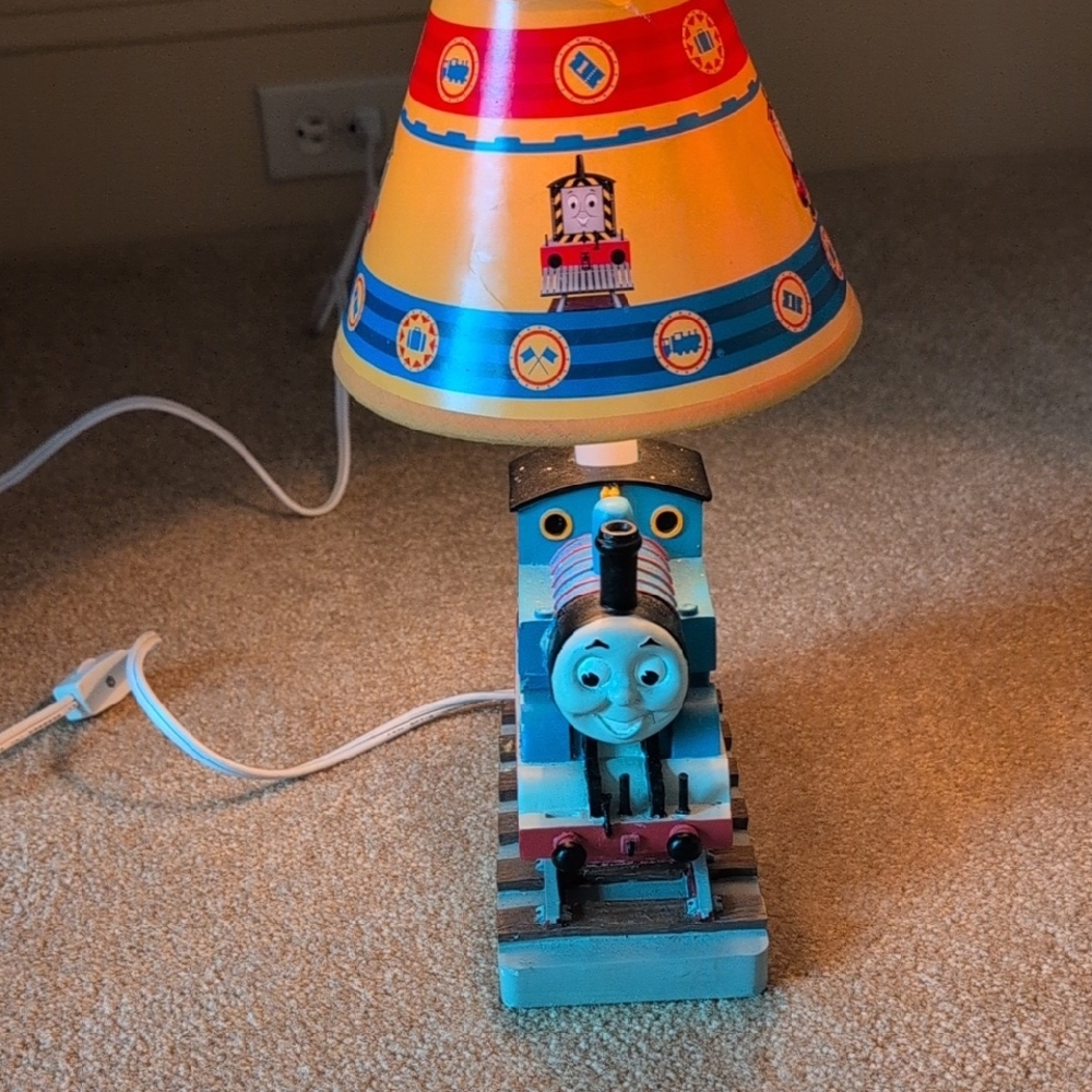 A Thomas The Train Solid Ceramic Night Light.  It Sets On Top A Railroad.